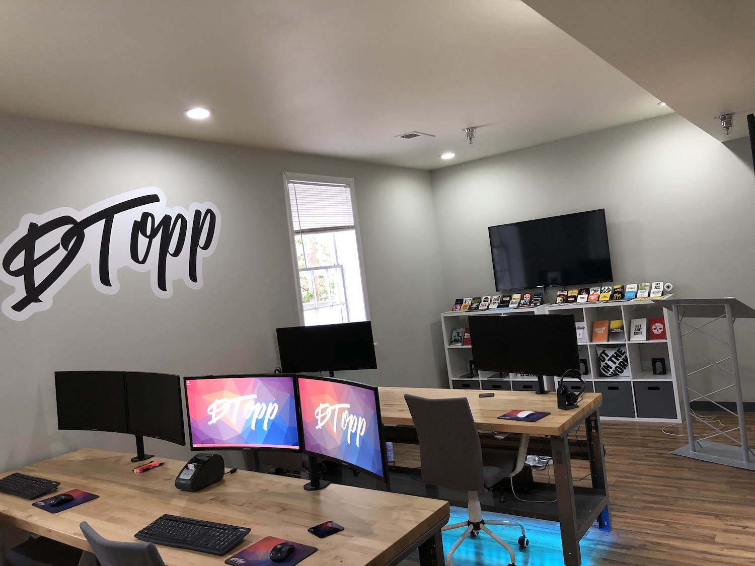 DTopp office with the logo on the wall above desks and monitors